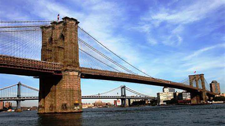 Photo of Brooklyn Bridge with blue sky background, New York, NY.